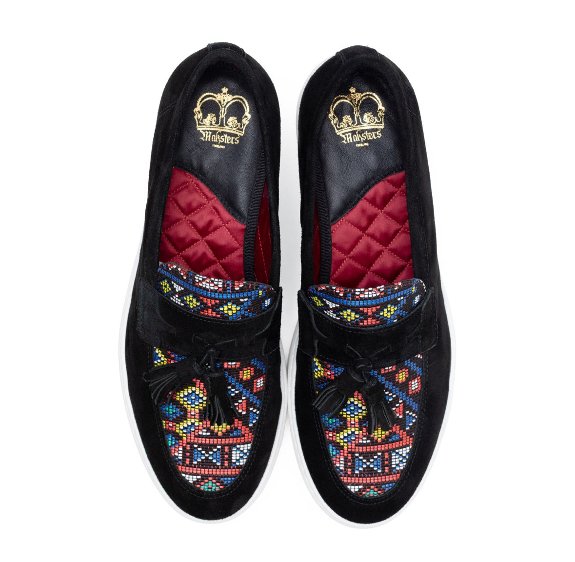 Pair of black suede loafers with colorful beadwork on a white background
