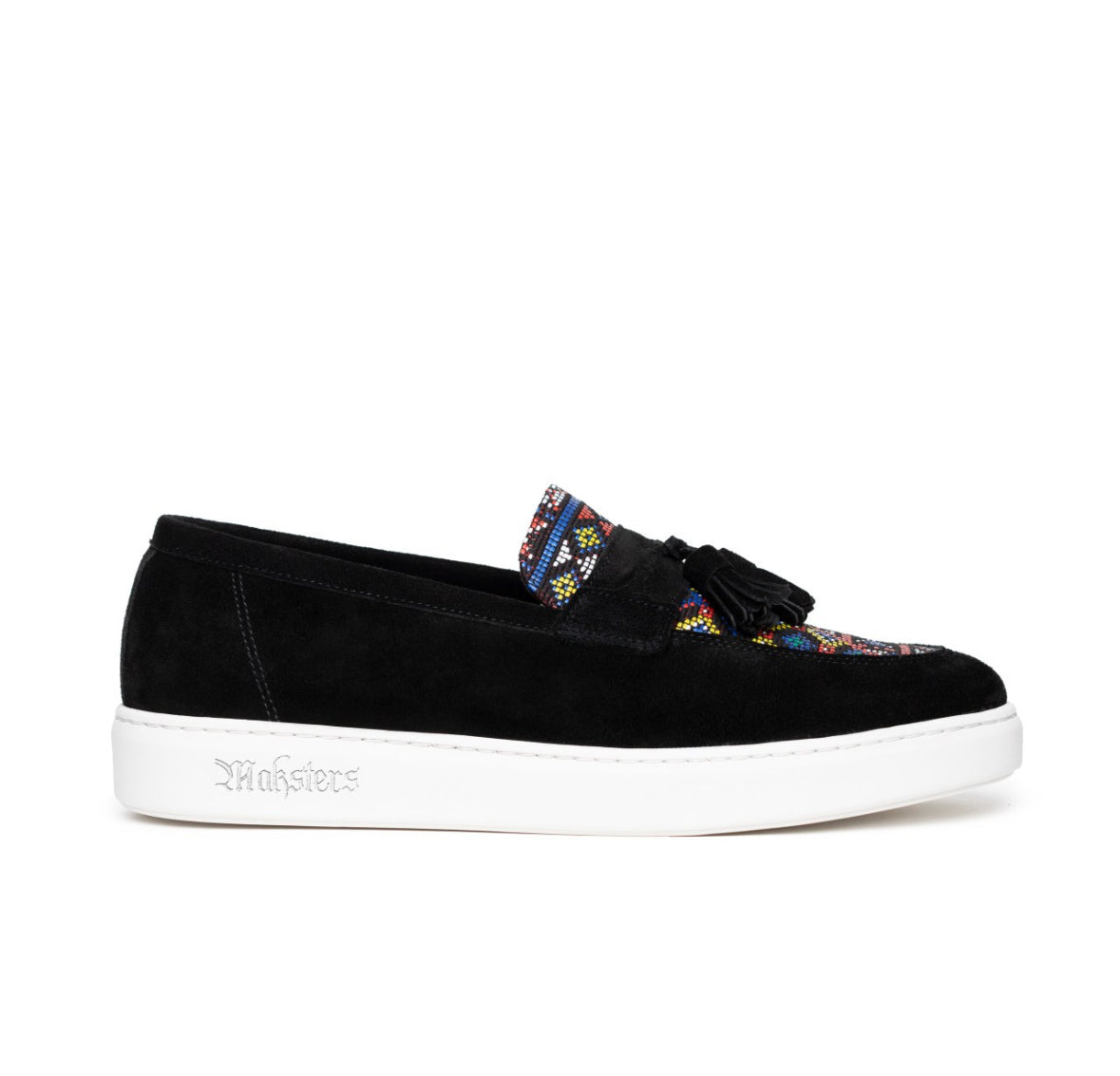 Black suede loafer with colorful patterned tassel on a white background
